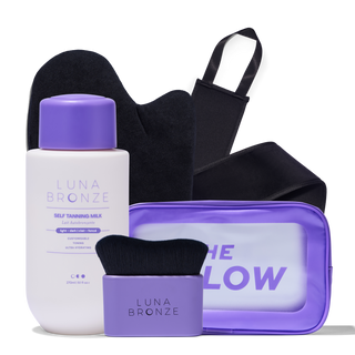 Luna Bronze self-tanning product set with a bottle, brush, and pouch on a white background